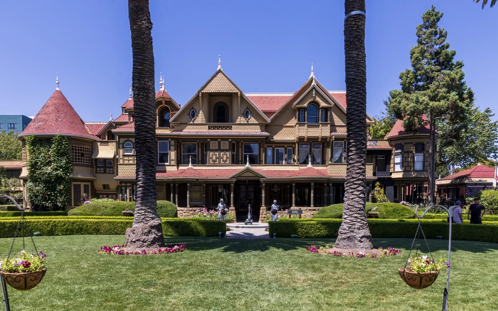Exterior view of the Winchester Mystery House Victorian mansion with its distinctive architecture and manicured grounds