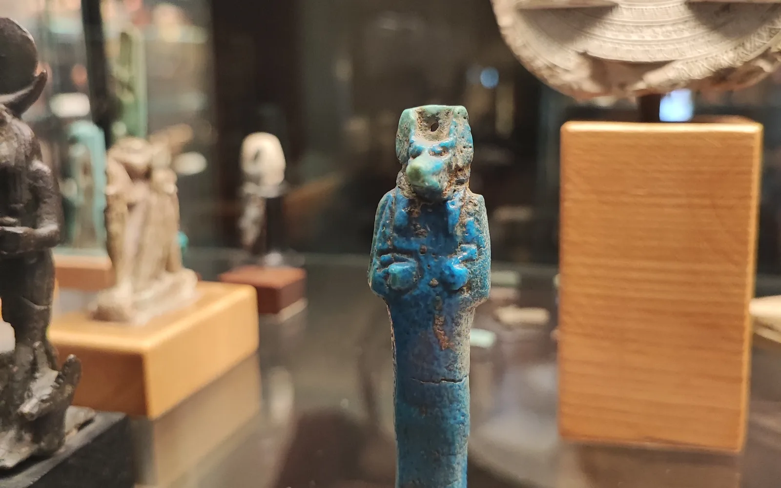 An Anubis statuette representing the Egyptian god, on display in a museum collection